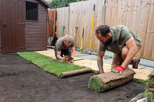 Laying out new rolls of turf
